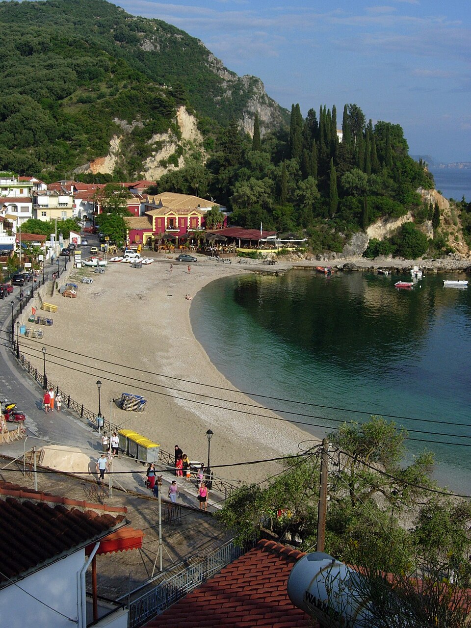 Krioneri beach in Parga, a small cove beside the road, with boats in the water.
